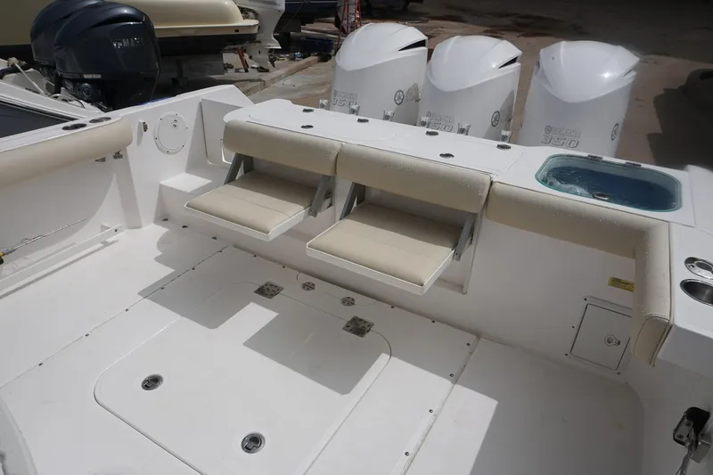 Slide: The Image of 2017 Everglades 355 CCX boat interior with seating and triple outboard engines. - 22