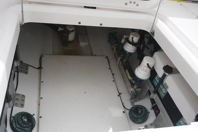 Slide: The Image of 2017 Everglades 355 CCX boat storage compartment with equipment and wiring. - 23