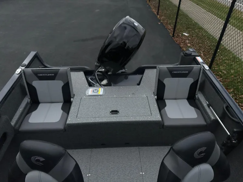 Slide: The Image of 2025 Crestliner 1650 Hawk WT boat interior with seating and motor. - 4