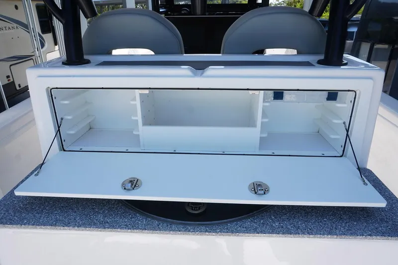 Slide: The Image of 2023 Twin Vee 280 GFX CC boat storage compartment with open lid and seating. - 12