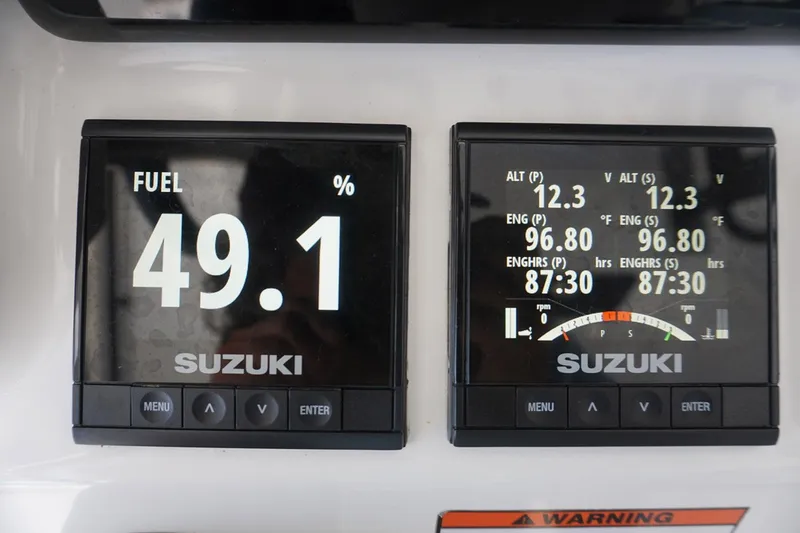 Slide: The Image of Suzuki engine displays on 2023 Twin Vee 280 GFX CC showing fuel and engine data. - 18