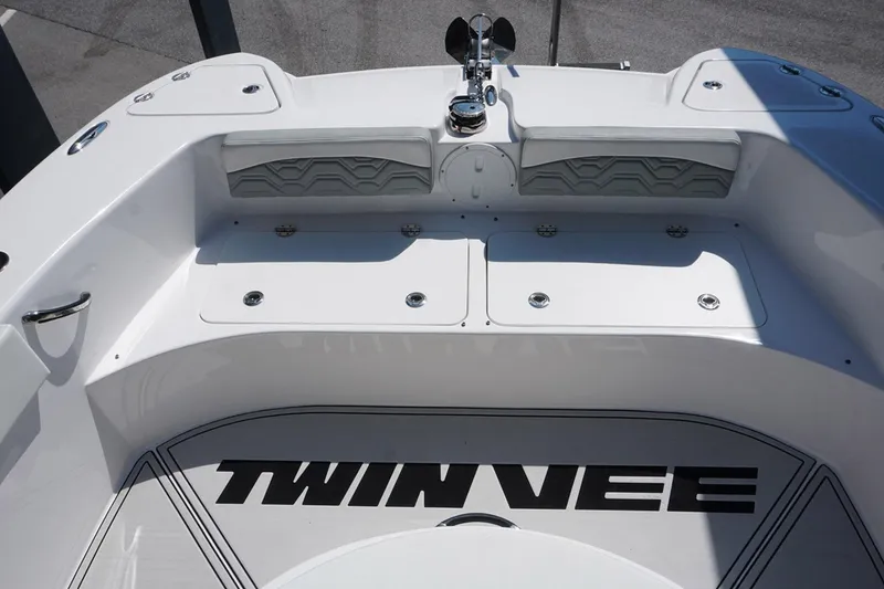Slide: The Image of 2023 Twin Vee 280 GFX CC boat deck with storage compartments and logo. - 21