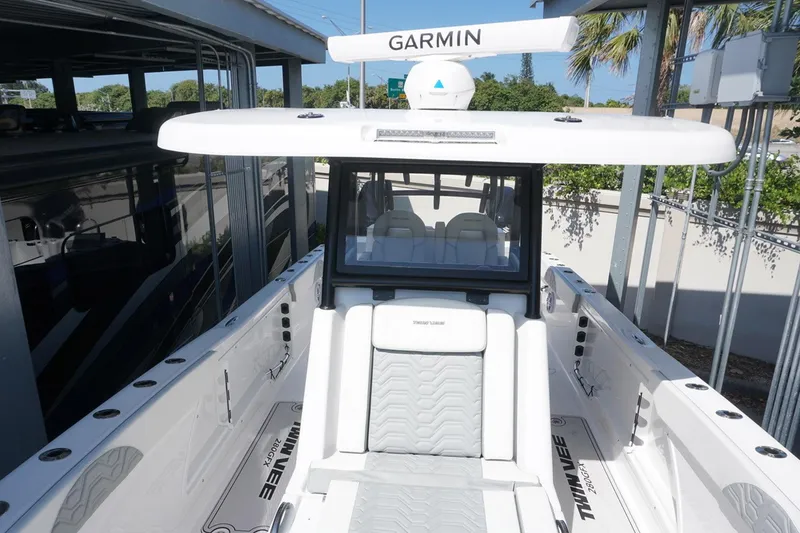 Slide: The Image of 2023 Twin Vee 280 GFX CC boat with Garmin equipment, sleek white design. - 24