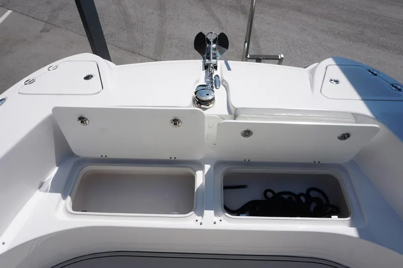 Slide: The Image of 2023 Twin Vee 280 GFX CC boat deck with storage compartments and anchor. - 26