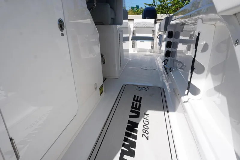 Slide: The Image of 2023 Twin Vee 280 GFX CC boat interior, featuring sleek white design and spacious layout. - 27