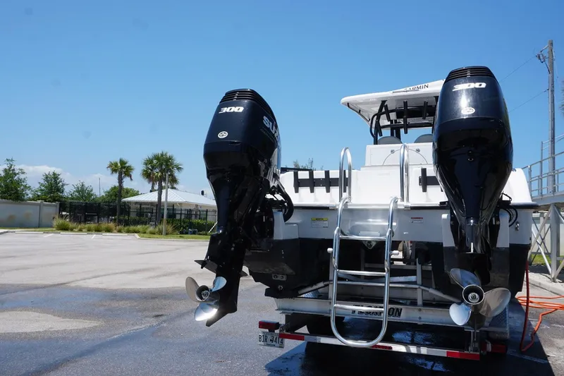 Slide: The Image of 2023 Twin Vee 280 GFX CC boat with dual outboard engines on a trailer. - 4