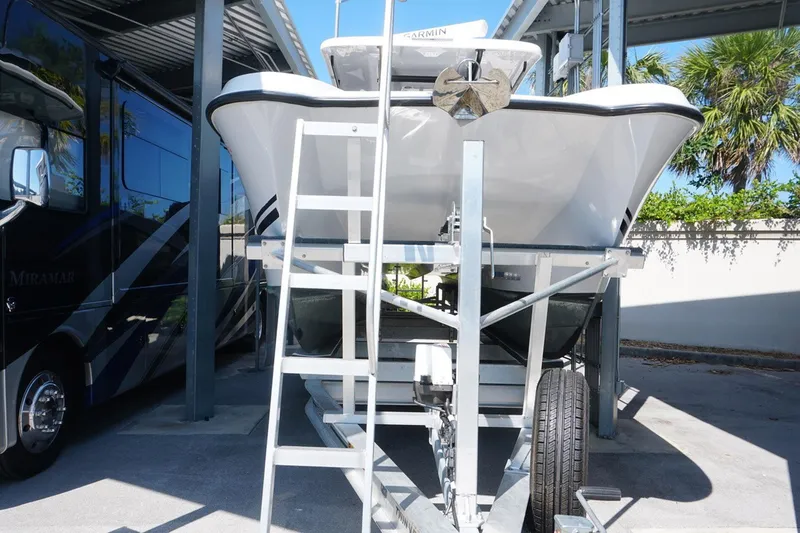 Slide: The Image of 2023 Twin Vee 280 GFX CC boat on trailer under a canopy. - 5