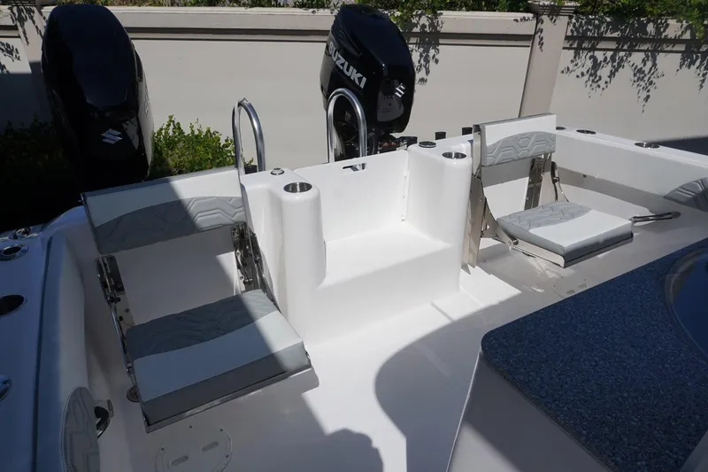Slide: The Image of 2023 Twin Vee 280 GFX CC boat interior with seating and dual Suzuki engines. - 9