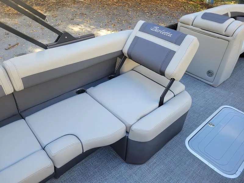 Slide: The Image of 2025 Barletta C22Q boat interior with gray and beige seating and adjustable headrest. - 12