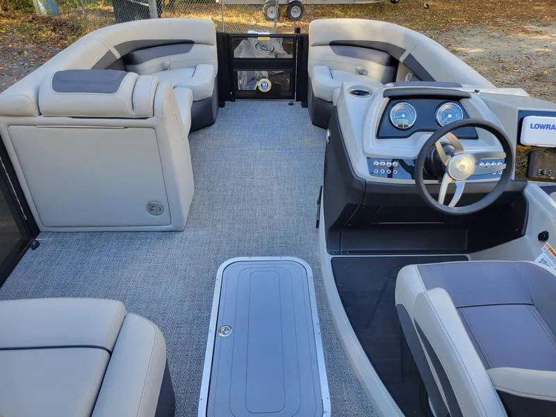 Slide: The Image of 2025 Barletta C22Q pontoon boat interior with modern seating and steering console. - 17
