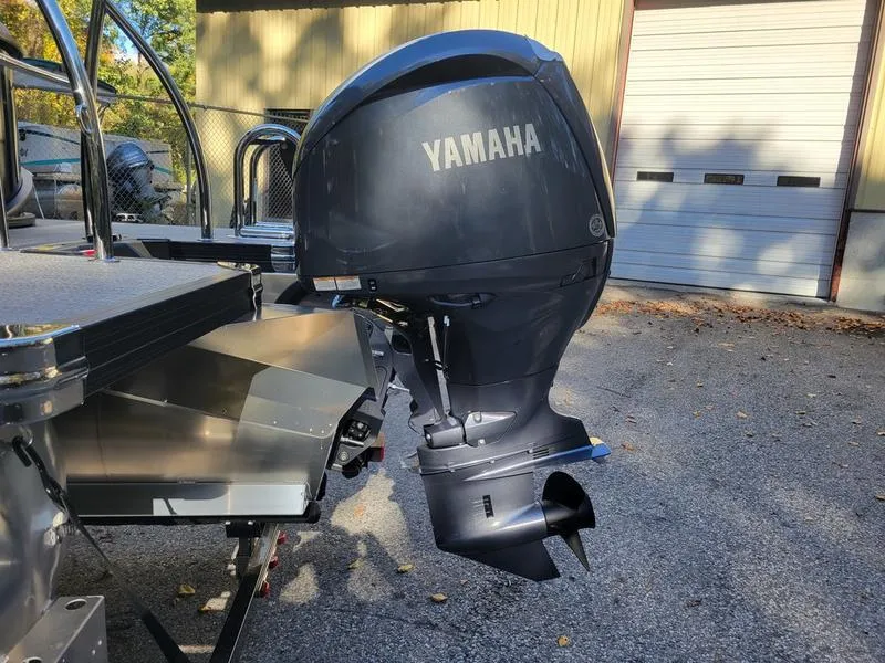 Slide: The Image of 2025 Barletta C22Q boat with Yamaha outboard motor in a sunny outdoor setting. - 8