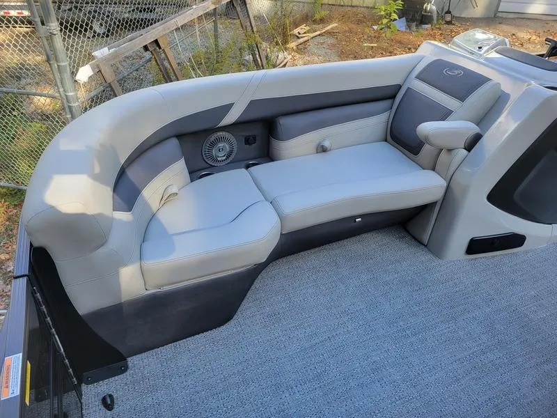 Slide: The Image of 2025 Barletta C22Q boat interior with gray seating and armrest. - 9