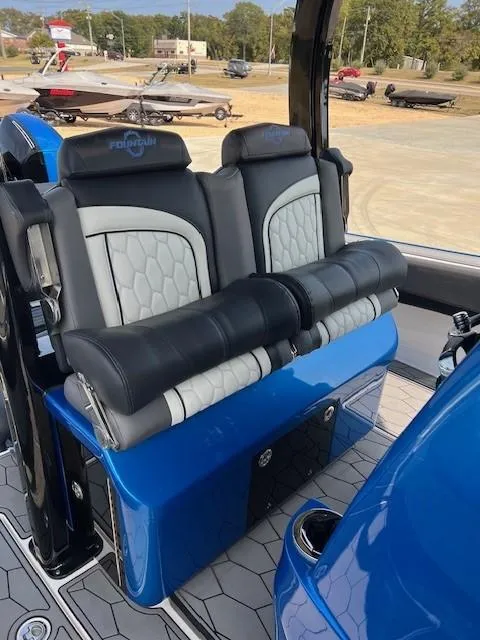 Slide: The Image of 2022 Fountain 39 NX boat seats with blue and black upholstery, parked on a lot. - 13