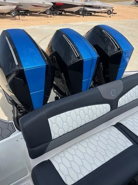 Slide: The Image of 2022 Fountain 39 NX boat with triple blue outboard engines and stylish seating. - 14