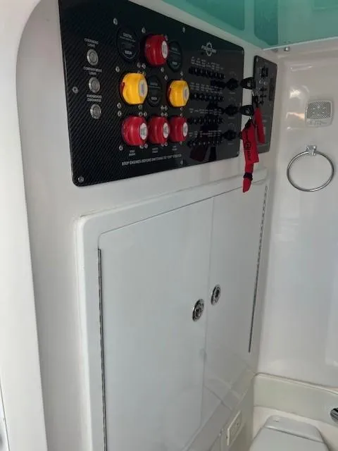 Slide: The Image of Control panel of 2022 Fountain 39 NX boat with switches and indicators. - 15
