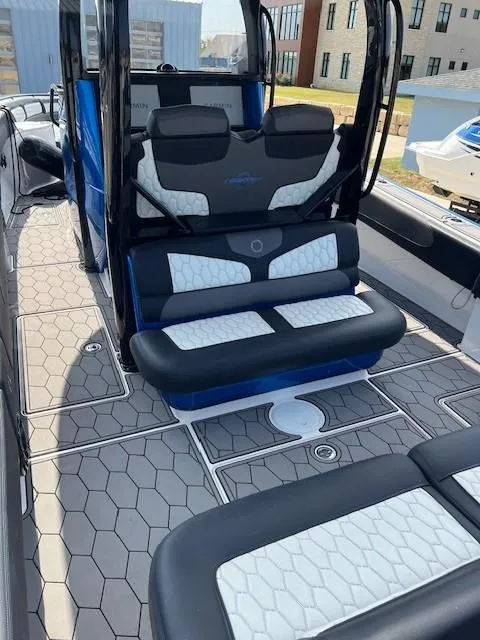 Slide: The Image of 2022 Fountain 39 NX boat interior with modern seating and hexagonal flooring design. - 7