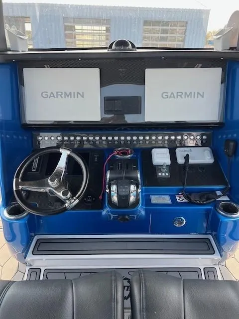 Slide: The Image of 2022 Fountain 39 NX boat dashboard with Garmin navigation displays and controls. - 8