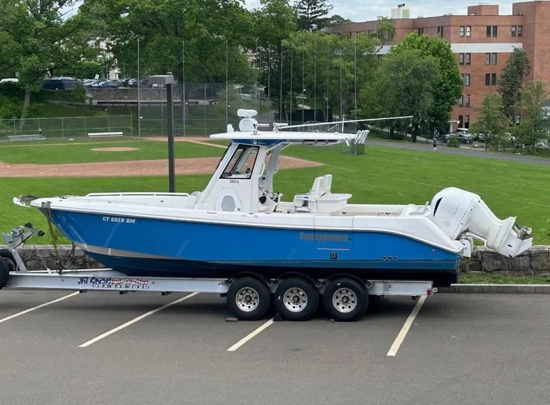 Slide: The Image of 2015 Everglades 295 Center Console boat on trailer in parking lot. - 1
