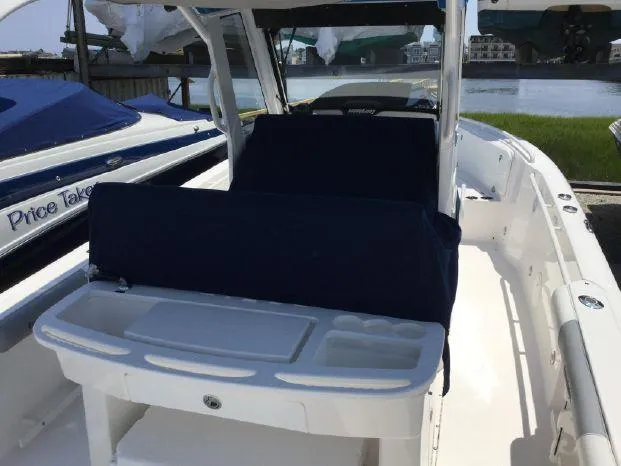 Slide: The Image of 2015 Everglades 295 Center Console boat with blue seating and white deck. - 10