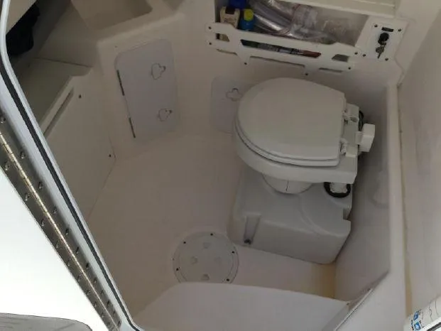 Slide: The Image of 2015 Everglades 295 Center Console boat interior with marine toilet. - 13