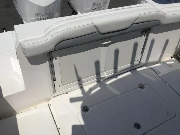 Slide: The Image of 2015 Everglades 295 Center Console boat interior with storage compartment and seating. - 14