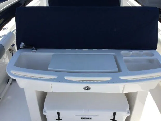 Slide: The Image of Everglades 295 Center Console 2015 boat with a white console and storage area. - 16