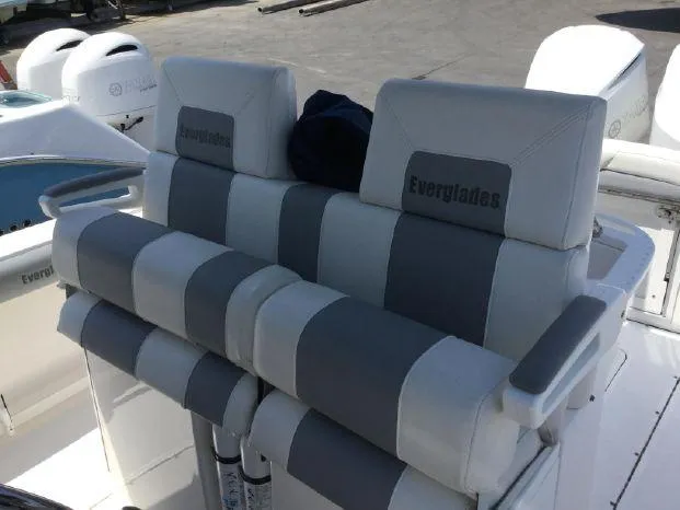 Slide: The Image of 2015 Everglades 295 Center Console boat seating with gray and white upholstery. - 17