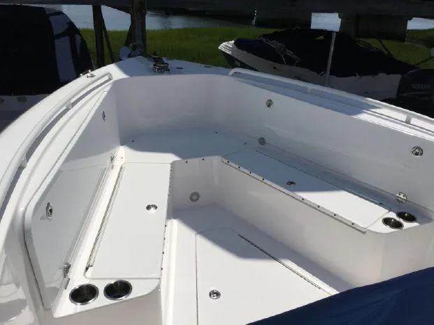 Slide: The Image of 2015 Everglades 295 Center Console boat interior with seating and cup holders. - 18