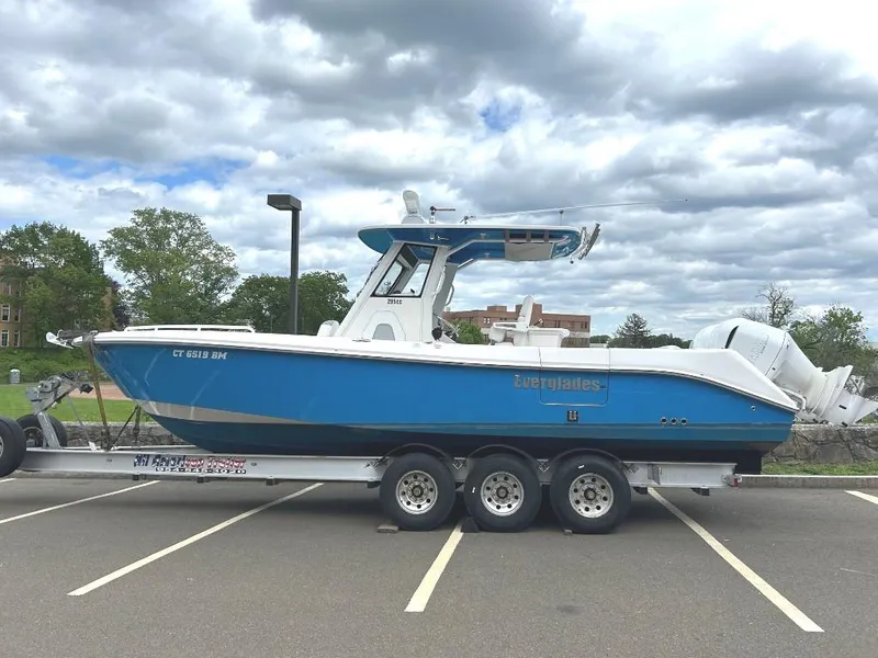 Slide: The Image of 2015 Everglades 295 Center Console boat on a trailer in a parking lot. - 6