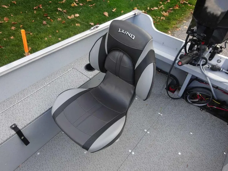 Slide: The Image of 2025 Lund 1600 Fury Heritage Edition boat seat, gray and black design, on a clean deck. - 6