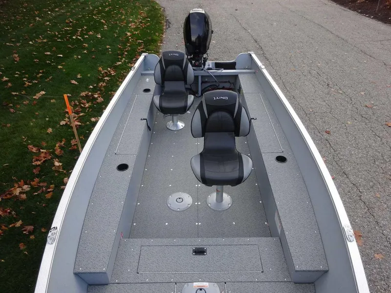 Slide: The Image of 2025 Lund 1600 Fury Heritage Edition boat with dual seats on a paved road. - 9