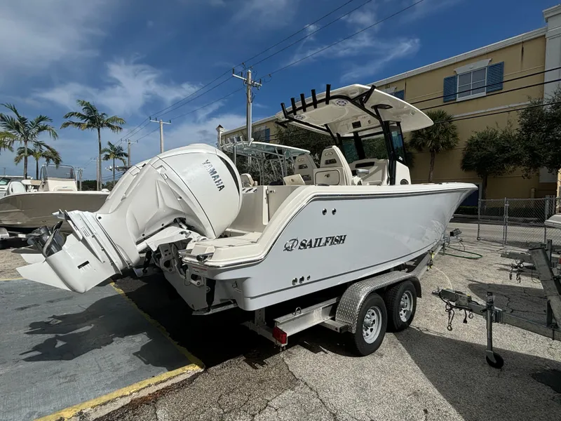 Slide: The Image of 2025 Sailfish 272 CC boat on trailer with Yamaha engine, parked outdoors. - 0