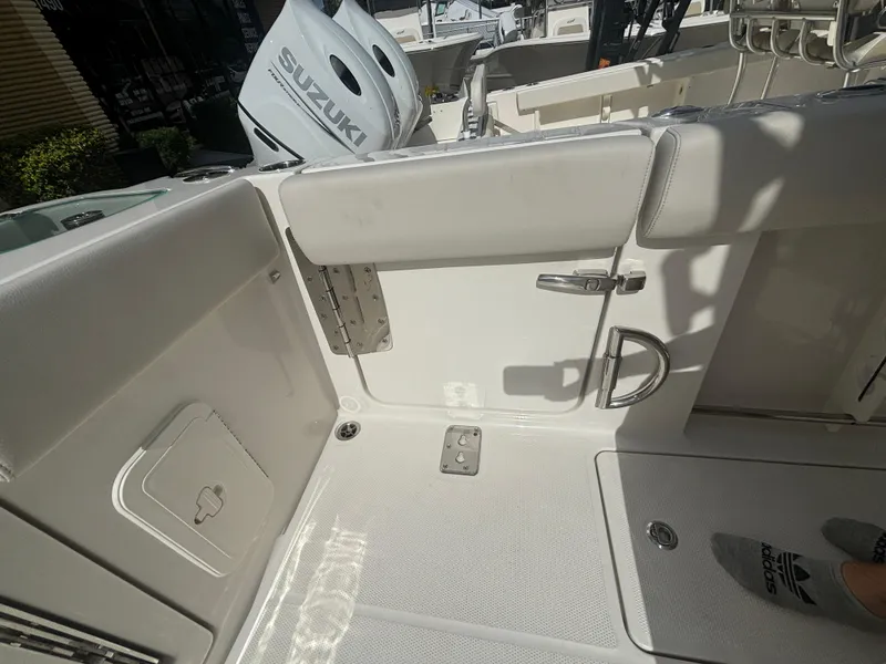 Slide: The Image of 2025 Sailfish 272 CC boat interior with Suzuki engine, featuring a clean deck and seating area. - 6