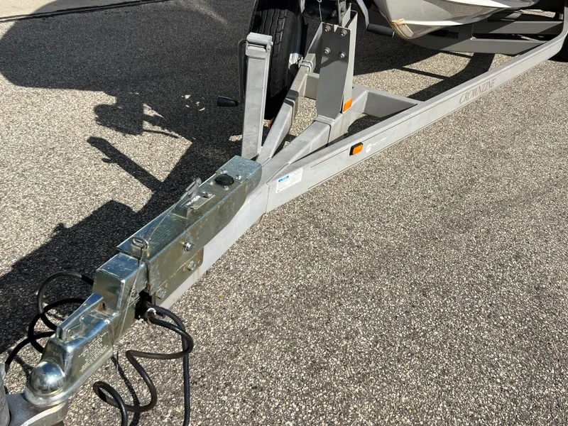Slide: The Image of Trailer hitch of a 2006 Crownline 260 LS boat on pavement. - 13