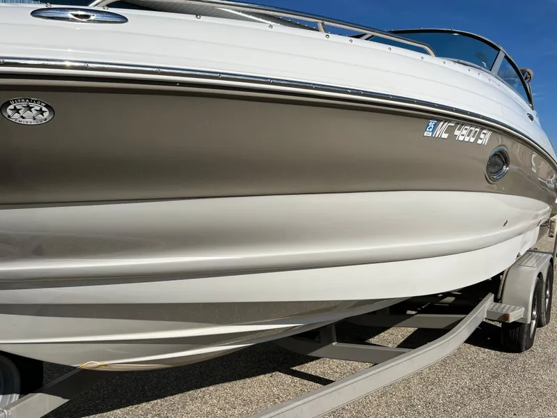 Slide: The Image of 2006 Crownline 260 LS boat on trailer, side view, sunny day. - 15