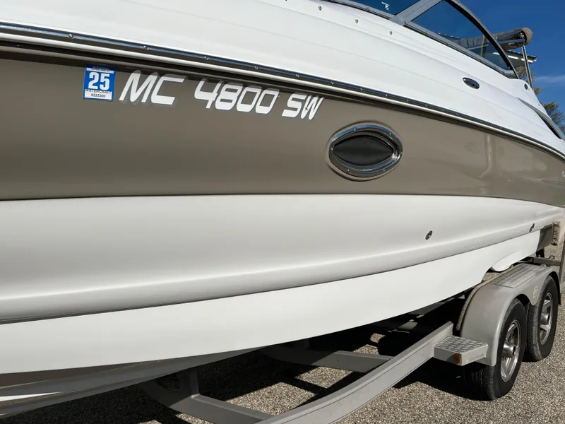 Slide: The Image of 2006 Crownline 260 LS boat on trailer, side view with registration number MC 4800 SW. - 16