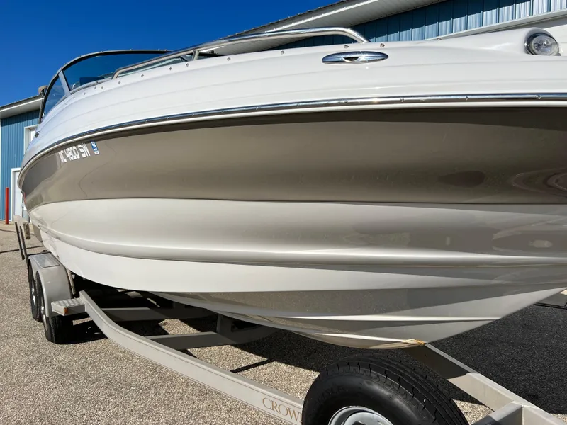 Slide: The Image of 2006 Crownline 260 LS boat on trailer, parked outdoors. - 25