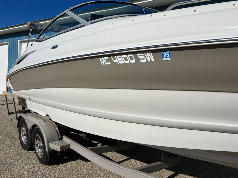 Slide: The Image of 2006 Crownline 260 LS boat on trailer, side view, white and beige exterior. - 26