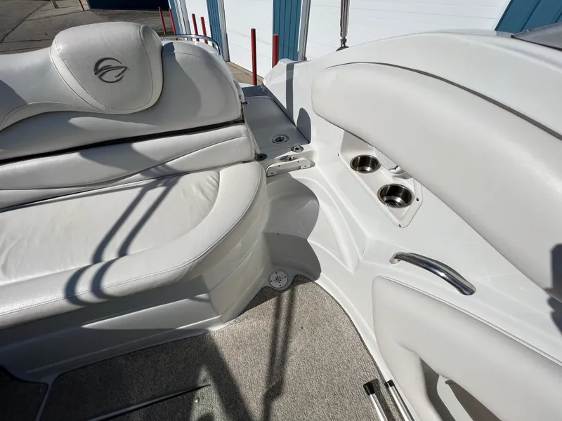 Slide: The Image of 2006 Crownline 260 LS boat interior with white leather seating and cup holders. - 36