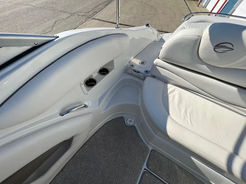 Slide: The Image of 2006 Crownline 260 LS boat interior with white seating and cup holders. - 37