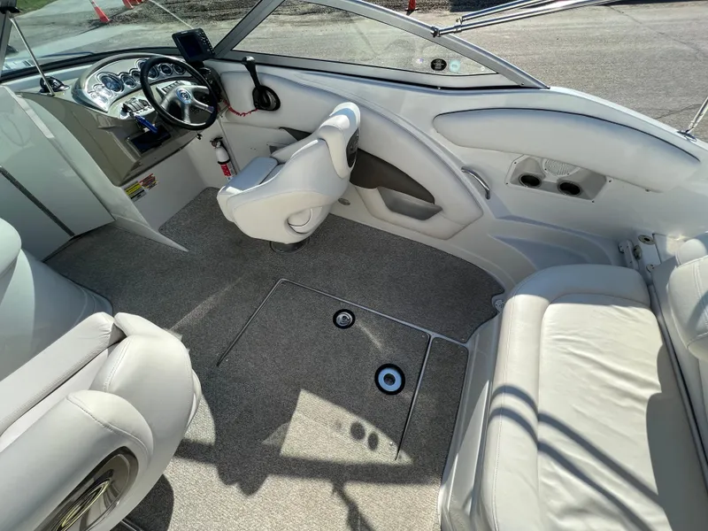 Slide: The Image of 2006 Crownline 260 LS boat interior with steering wheel, seating, and carpeted floor. - 38
