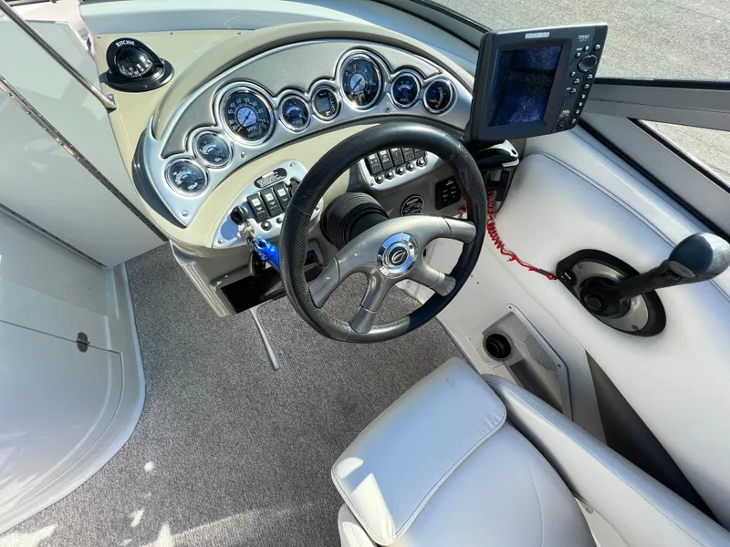 Slide: The Image of 2006 Crownline 260 LS boat dashboard with steering wheel and gauges. - 41