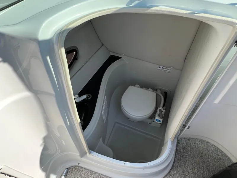 Slide: The Image of 2006 Crownline 260 LS boat interior with compact marine toilet. - 42