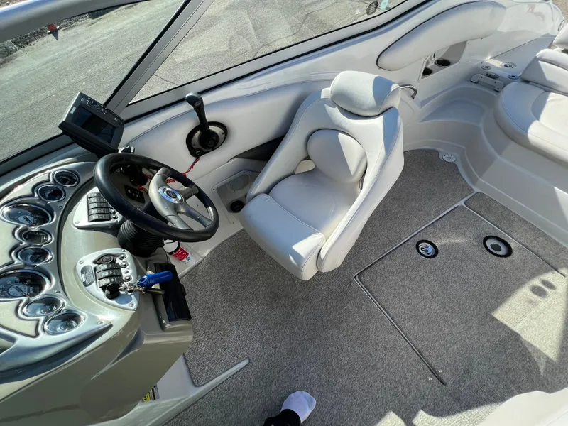 Slide: The Image of 2006 Crownline 260 LS boat interior with steering wheel and seating area. - 46
