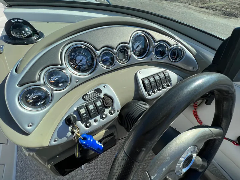 Slide: The Image of Dashboard of 2006 Crownline 260 LS boat with gauges and steering wheel. - 49