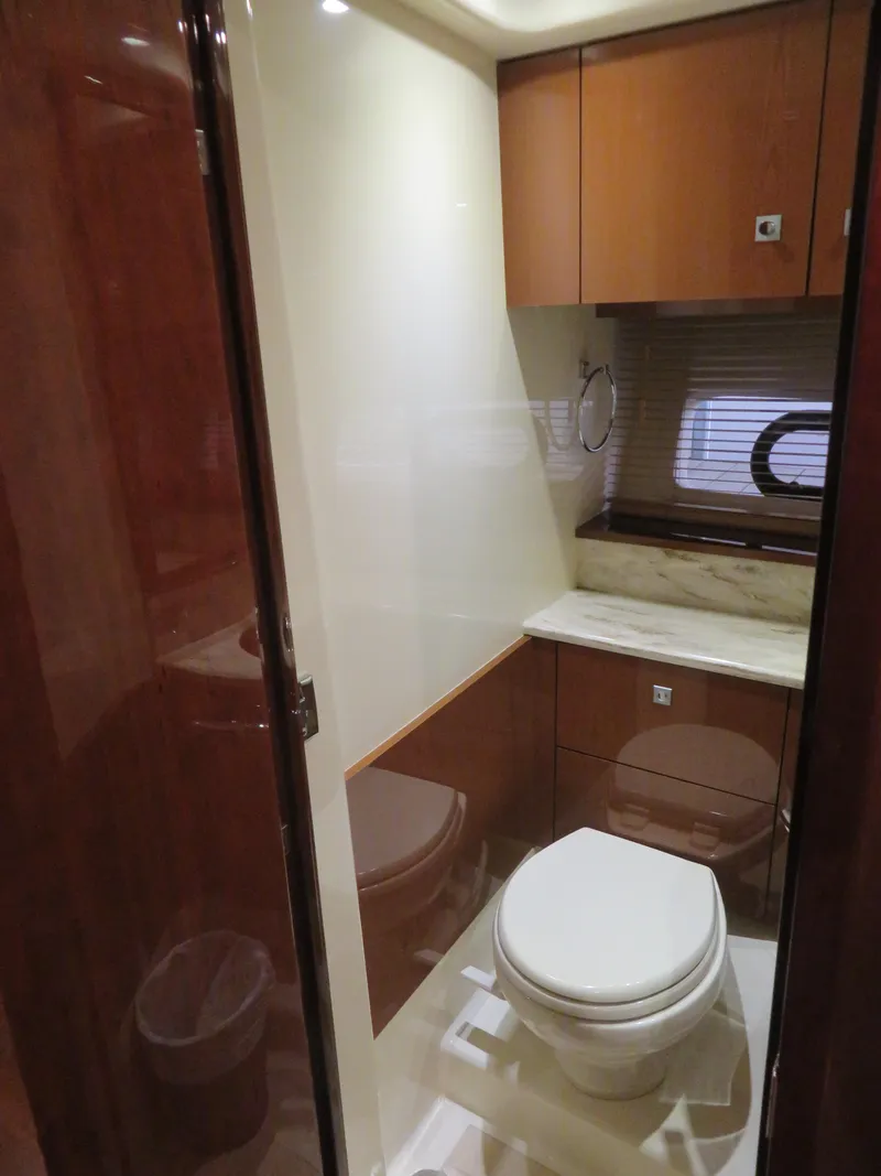 Slide: The Image of 2015 Sea Ray 470 Sundancer bathroom interior with shower and window. - 11