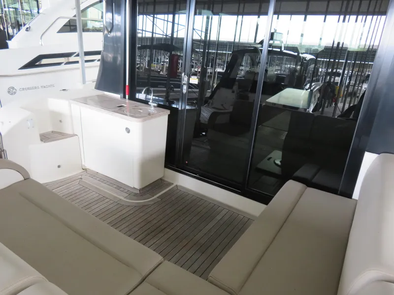 Slide: The Image of 2015 Sea Ray 470 Sundancer yacht interior with seating and kitchenette. - 3