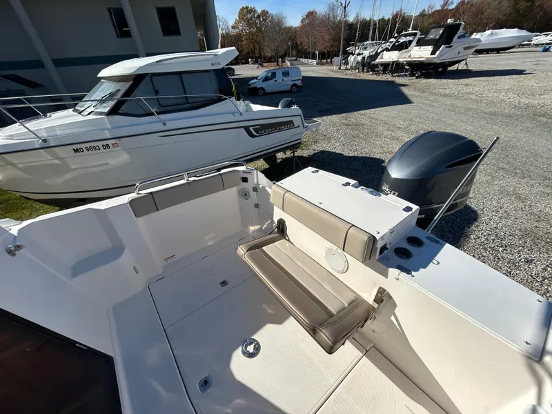 Slide: The Image of 2021 Cutwater C-24 Coupe boat interior with seating and outboard motor. - 2