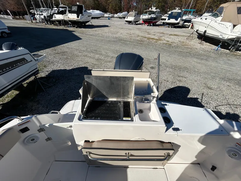 Slide: The Image of 2021 Cutwater C-24 Coupe boat with outdoor grill and sink in marina setting. - 3