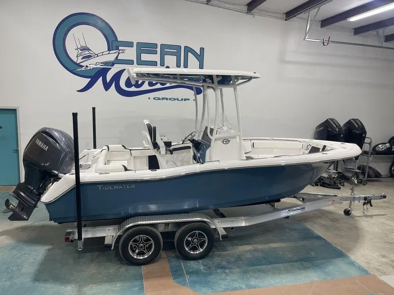 Slide: The Image of 2025 Tidewater 210 LXF boat on trailer in showroom with Yamaha outboard motor. - 1
